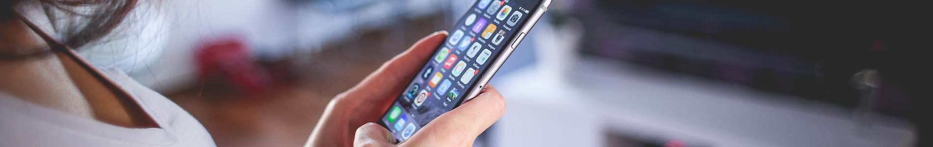 A photo of a woman using a phone.